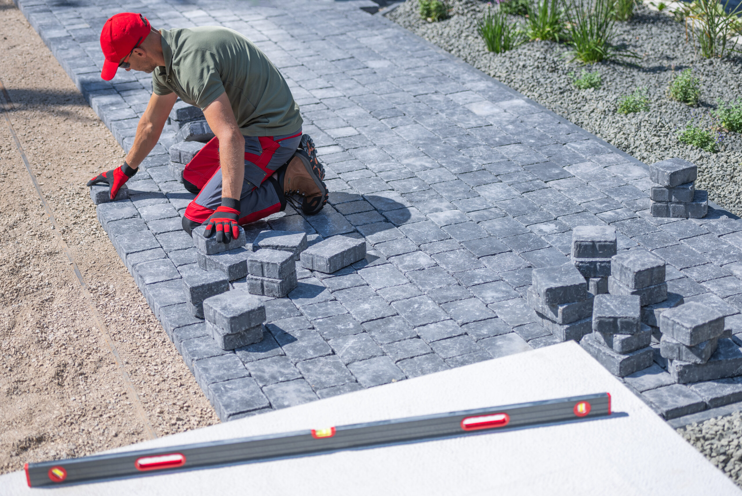 Professional paving contractors Northern Suburbs installing interlock driveway pavers.